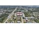 Expansive aerial view of a residential area with a red-roofed commercial building and a home pinpointed at 857 Palmetto St, Englewood, FL 34223