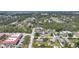 Scenic aerial view showing a neighborhood setting with tree coverage and the pinpointed property near a commercial building at 857 Palmetto St, Englewood, FL 34223