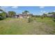 Expansive backyard featuring a light-colored single-story home with tropical landscaping at 857 Palmetto St, Englewood, FL 34223