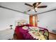 Bedroom with a sunflower themed comforter, ceiling fan, and a view into another room at 857 Palmetto St, Englewood, FL 34223