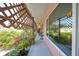 Exterior patio featuring lattice decor, potted plants, and benches at 857 Palmetto St, Englewood, FL 34223