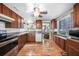 Well-lit kitchen with wood cabinets, hardwood floors, and modern appliances at 857 Palmetto St, Englewood, FL 34223