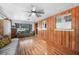 Spacious living area with hardwood floors, wood paneled walls and comfortable seating at 857 Palmetto St, Englewood, FL 34223