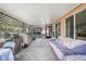 Covered back patio featuring an outdoor kitchen, seating, and access to the backyard at 857 Palmetto St, Englewood, FL 34223