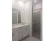 Bathroom boasts a double sink vanity and a glass-enclosed tiled shower at 8661 Seasalt Loop, Englewood, FL 34224