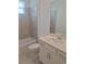 Clean bathroom with a single vanity, white cabinets, and tiled shower-tub combo at 8661 Seasalt Loop, Englewood, FL 34224