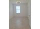 Bright bedroom featuring tile floors, a modern ceiling fan, and a window with natural light at 8661 Seasalt Loop, Englewood, FL 34224