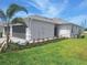 Side view of this lovely home with well-manicured lawn and landscaping at 8661 Seasalt Loop, Englewood, FL 34224