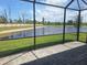 Screened-in patio with a view of the pond and manicured backyard at 8661 Seasalt Loop, Englewood, FL 34224