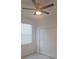 A bedroom with white walls, window with blinds, ceiling fan, and closet at 8673 Seasalt Loop, Englewood, FL 34224