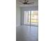 Bright room with tiled floor leading to a sliding glass door to the exterior at 8673 Seasalt Loop, Englewood, FL 34224