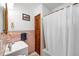 Bathroom with pink tiling, shower with curtain and a vanity with sink at 868 Harvard St, Englewood, FL 34223
