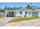 A well-maintained home with a carport attached and well-kept lawn with a concrete driveway at 868 Harvard St, Englewood, FL 34223