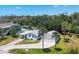 Well-kept single-Gathering home featuring a long drive and separate garage for multiple cars with lush landscaping at 868 Harvard St, Englewood, FL 34223