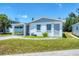 A well-maintained white home with a carport attached and lush lawn at 868 Harvard St, Englewood, FL 34223