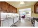 Open concept kitchen with bright lighting, wood cabinets and dining area at 868 Harvard St, Englewood, FL 34223
