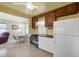 Bright kitchen leading to dining area, with ample cabinet space and modern appliances at 868 Harvard St, Englewood, FL 34223