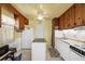 Bright kitchen with a center island, wood cabinets, and white appliances at 868 Harvard St, Englewood, FL 34223