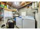 Practical laundry room with washer, dryer, and shelving for organized storage solutions at 868 Harvard St, Englewood, FL 34223