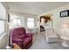 Bright living room with terrazzo floors featuring a dining table and access to the kitchen at 868 Harvard St, Englewood, FL 34223