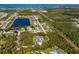 An aerial view shows a sprawling property with mature landscaping, pool, and surrounding natural beauty at 9144 Spring Valley Rd, Englewood, FL 34224