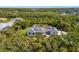 Expansive aerial view of the home's picturesque estate, lush landscaping, and outdoor pool area at 9144 Spring Valley Rd, Englewood, FL 34224
