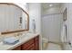 Bathroom featuring vanity with drawers, a curved mirror and separate toilet and shower at 9144 Spring Valley Rd, Englewood, FL 34224