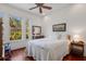 Light-filled bedroom with hardwood floors and a large window at 9144 Spring Valley Rd, Englewood, FL 34224