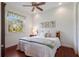 Bedroom with hardwood floors, a ceiling fan, and a large window at 9144 Spring Valley Rd, Englewood, FL 34224