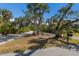 Long, curving driveway surrounded by mature trees and lush landscaping leading to a private residence at 9144 Spring Valley Rd, Englewood, FL 34224