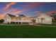 Beautiful home exterior with a large porch, well-maintained lawn, and picturesque landscaping, perfect for outdoor living at 9144 Spring Valley Rd, Englewood, FL 34224