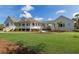 Lovely home with a wraparound porch and manicured lawn, offering a perfect blend of comfort and elegance at 9144 Spring Valley Rd, Englewood, FL 34224