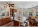 Gourmet kitchen with stainless steel appliances, a center island, bar stools, and custom cabinetry at 9144 Spring Valley Rd, Englewood, FL 34224