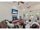 Inviting living room features a fireplace, comfortable seating, and bright natural light at 9144 Spring Valley Rd, Englewood, FL 34224