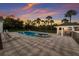 Backyard oasis featuring a sparkling pool, spa, covered outdoor kitchen, and ample patio space perfect for entertaining at 9144 Spring Valley Rd, Englewood, FL 34224