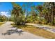The winding street with bench seating highlights the scenic landscaping and natural surroundings at 9144 Spring Valley Rd, Englewood, FL 34224