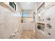 Bright bathroom featuring tiled shower, dual shower heads, built in bench, and convenient built in toiletry shelving at 9470 Wacker Ter, Port Charlotte, FL 33981