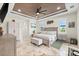 Comfortable bedroom with tray ceiling, fan, plantation shutters, and travertine flooring at 9470 Wacker Ter, Port Charlotte, FL 33981