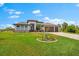 Beautiful single Gathering home with a three car garage, well manicured lawn, and upgraded paver driveway at 9470 Wacker Ter, Port Charlotte, FL 33981