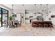 Open-concept kitchen and dining area with travertine flooring, pendant lighting, and access to the patio at 9470 Wacker Ter, Port Charlotte, FL 33981