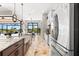 Bright kitchen with island, granite counters, farmhouse sink, pendant lights and stainless steel appliances at 9470 Wacker Ter, Port Charlotte, FL 33981