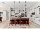 Well-lit kitchen with granite island, stainless appliances, modern lighting, and abundant cabinet space at 9470 Wacker Ter, Port Charlotte, FL 33981