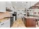 Gourmet kitchen featuring granite countertops, pendant lighting, stainless steel appliances, and custom cabinets at 9470 Wacker Ter, Port Charlotte, FL 33981