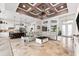 Spacious living room open to the kitchen, featuring a decorative ceiling and travertine floors at 9470 Wacker Ter, Port Charlotte, FL 33981