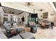 Spacious covered patio featuring a summer kitchen, comfortable seating and elegant fireplace to create the ultimate outdoor retreat at 9470 Wacker Ter, Port Charlotte, FL 33981
