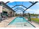 Enjoy the outdoors with a screened-in pool offering a tranquil oasis, a summer kitchen, and stunning views of the lake at 9470 Wacker Ter, Port Charlotte, FL 33981
