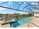 A serene pool with a spa, surrounded by lush landscaping and views of a canal at 9470 Wacker Ter, Port Charlotte, FL 33981