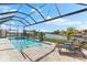 Enjoy the outdoors with a screened-in pool offering a tranquil oasis with lounge chairs for relaxation at 9470 Wacker Ter, Port Charlotte, FL 33981