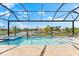 Enjoy the outdoors with a screened-in pool offering a tranquil oasis with views of the lake at 9470 Wacker Ter, Port Charlotte, FL 33981