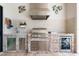 Summer kitchen featuring a stainless steel grill, beverage fridge, and ample counter space, perfect for outdoor gatherings at 9470 Wacker Ter, Port Charlotte, FL 33981